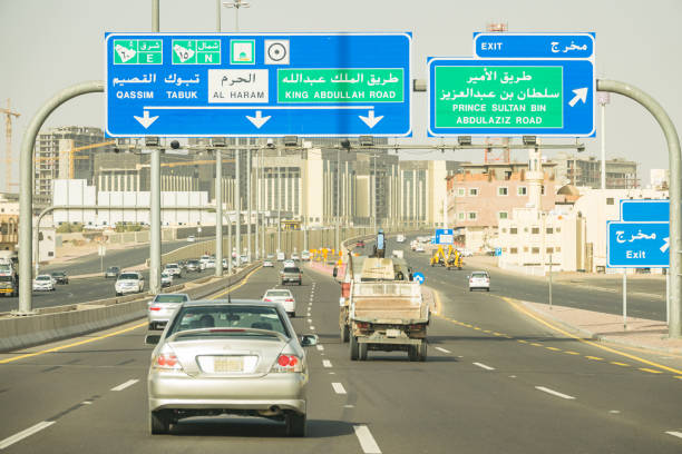 Cars drive on highway in Medina Saudi Arabia on a sunny day.